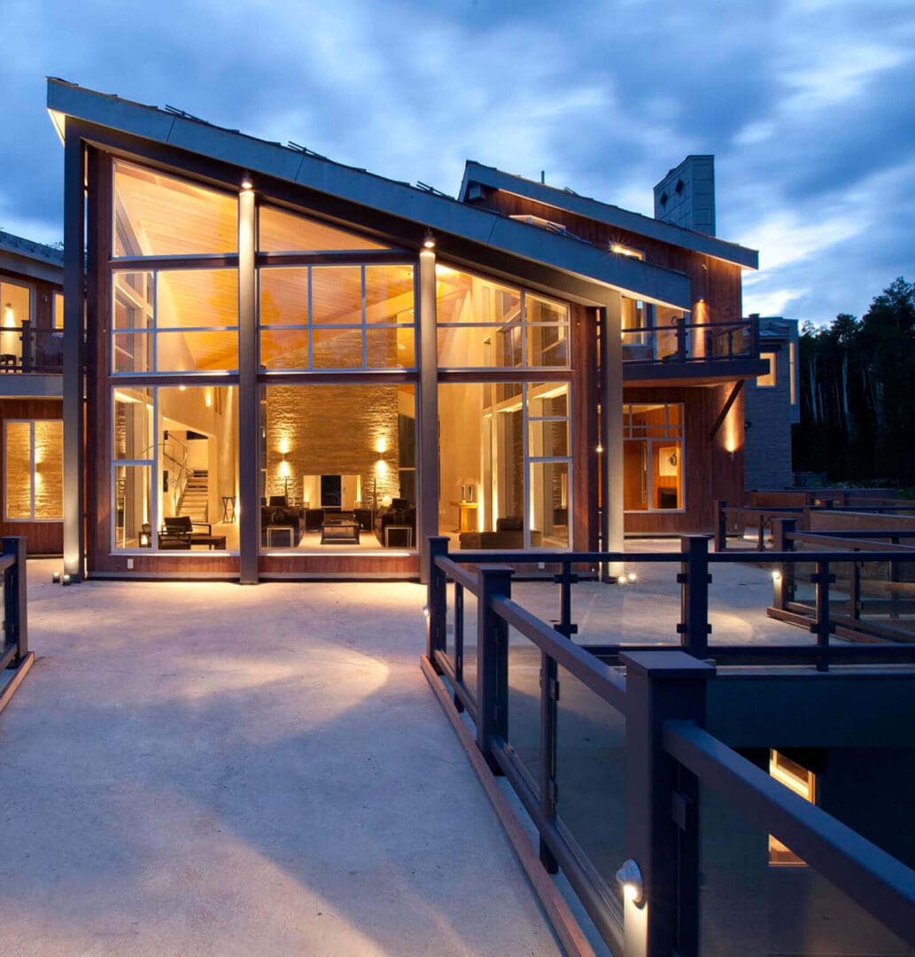 Modern house with large windows at dusk.