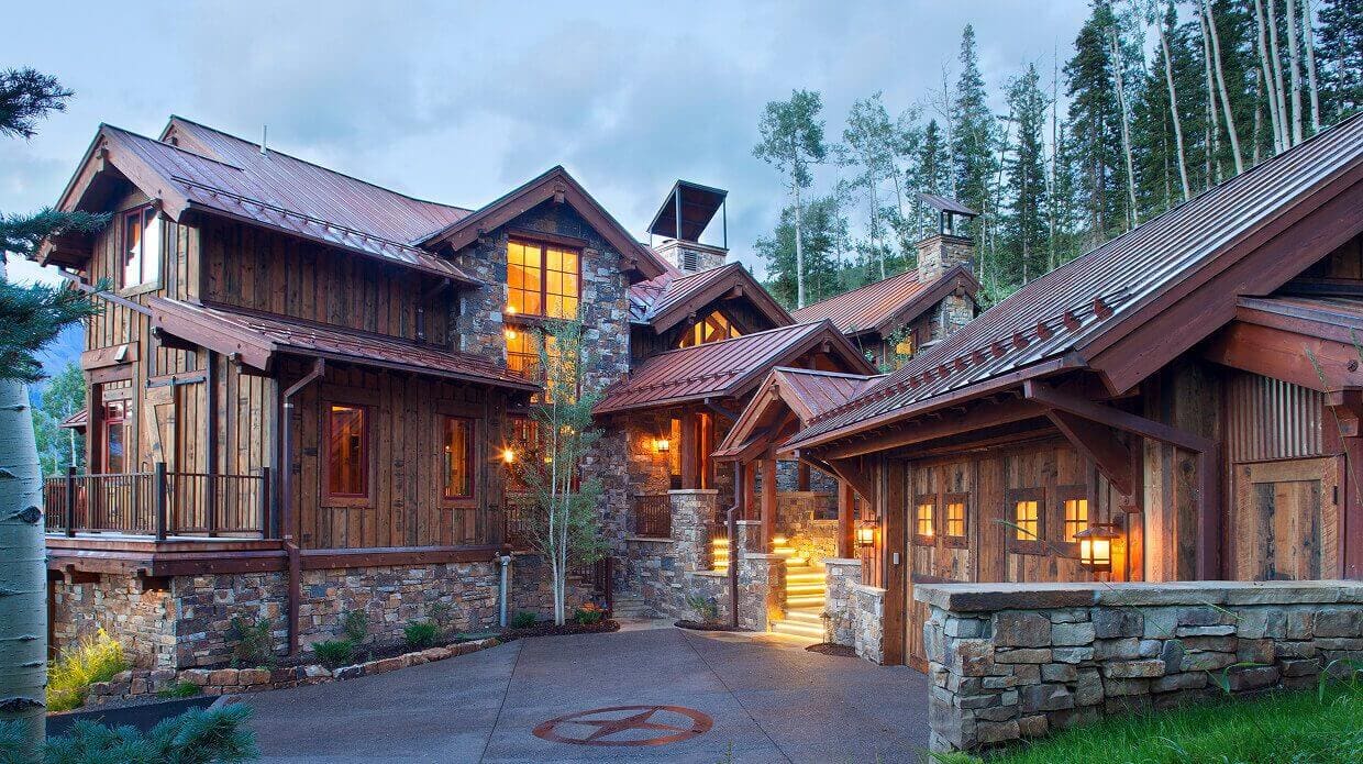 Rustic wooden house surrounded by trees.