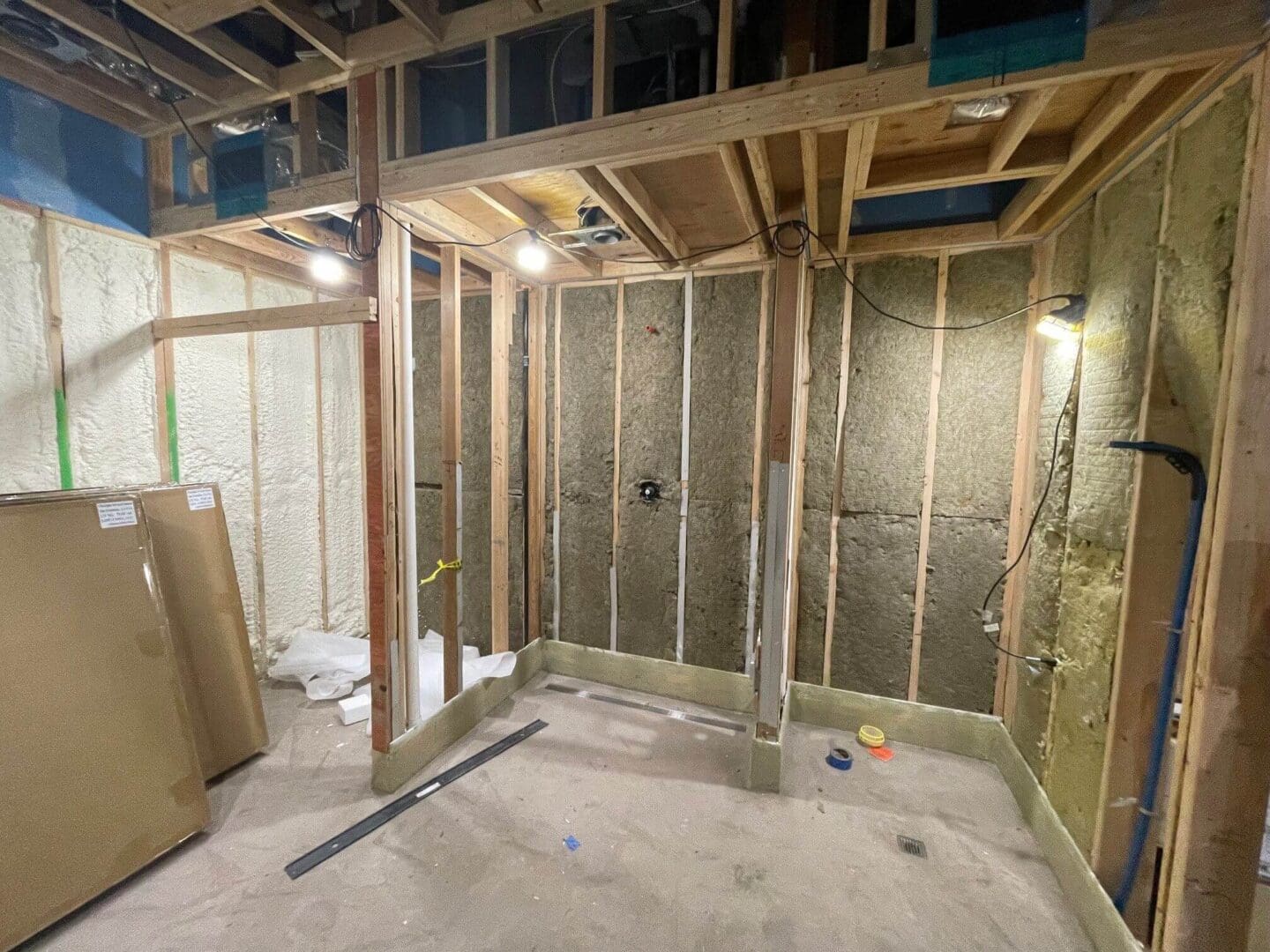 Insulated wall framing in unfinished room under construction.