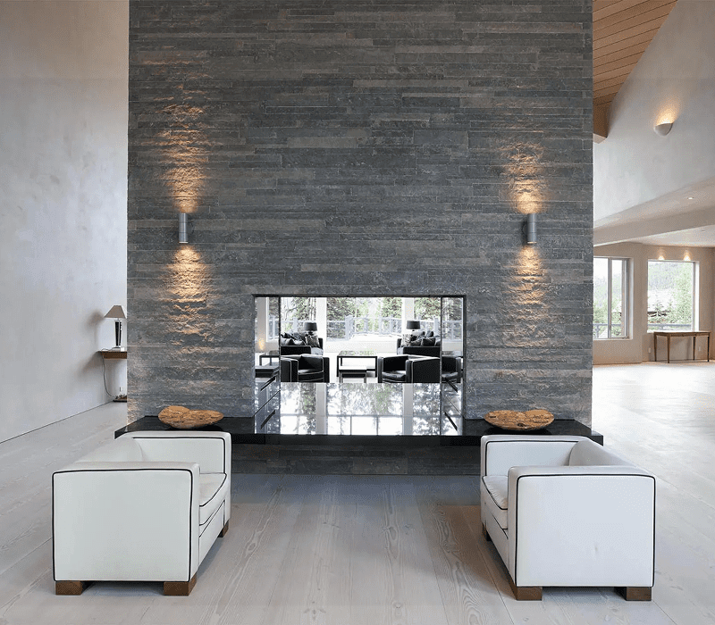 Modern living room with a sleek fireplace and white seating.