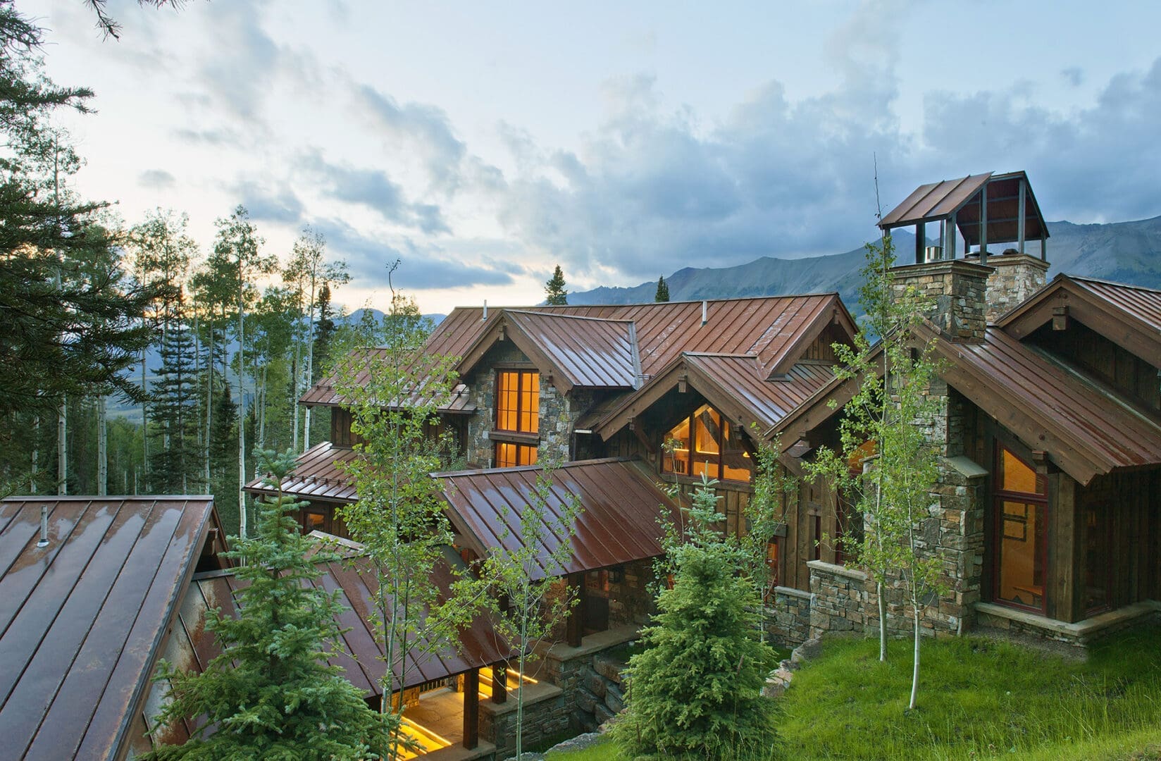 Rustic mountain lodge with lit windows